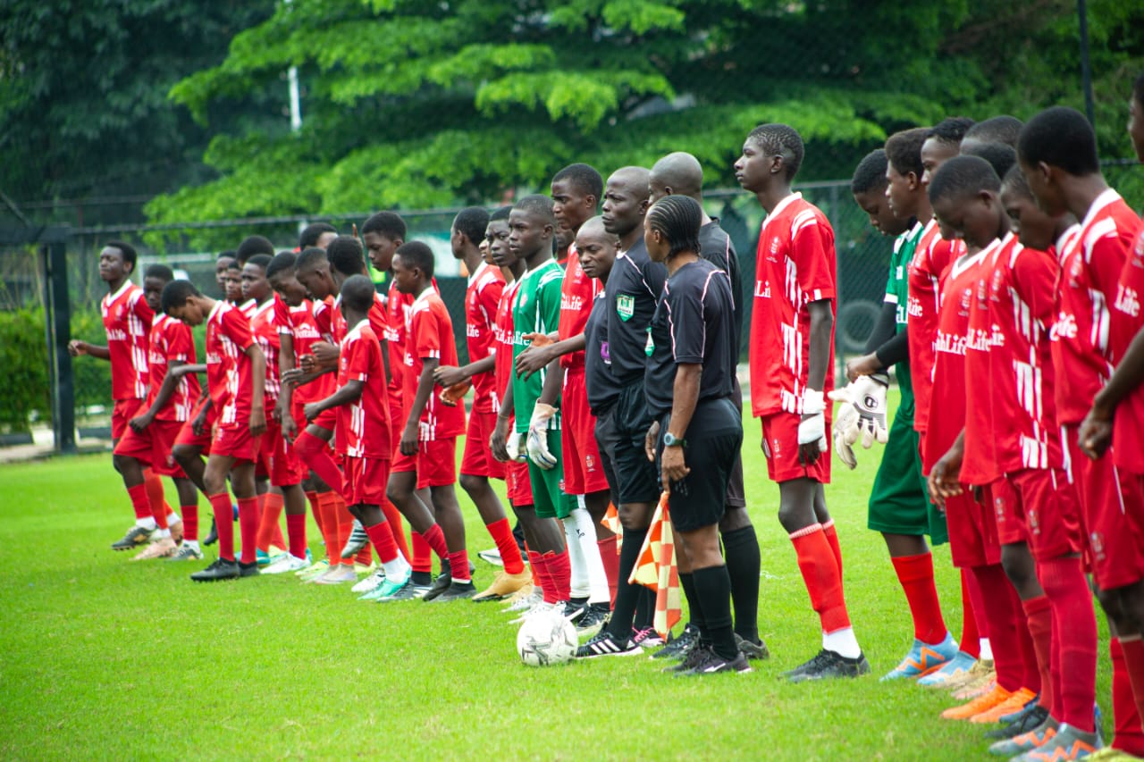 Teams and match officials lined up before an age grade tournament kick-off