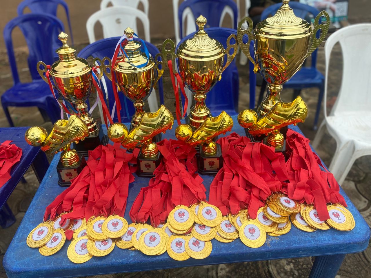 Trophies, golden boots and medals laid out for the age grade tournament