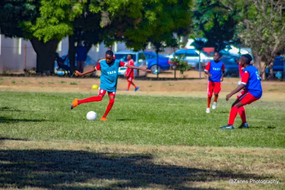 School player striking the ball during a YAFA development match