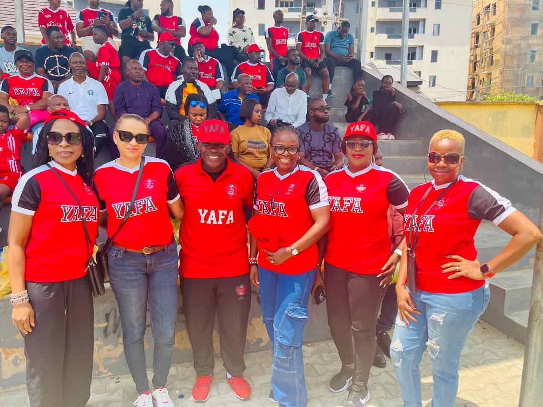 YAFA Mums in matching jerseys and caps in front of the supporters' stand