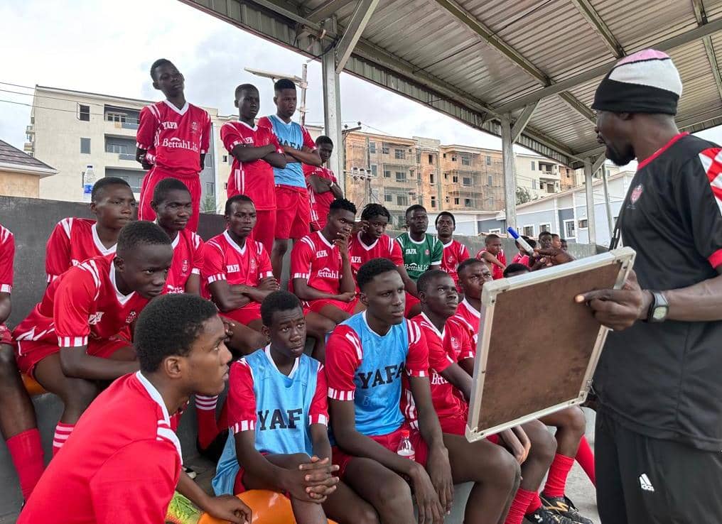 YAFA coach delivering a tactical team talk with a whiteboard